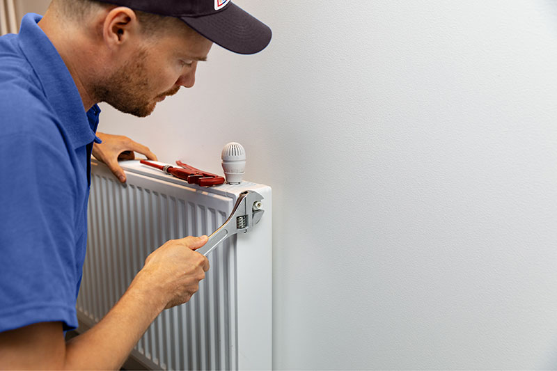 Heating & Air Contractor fixing a radiator