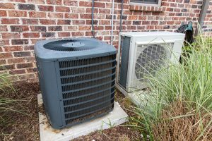 two ac units sitting outside of house